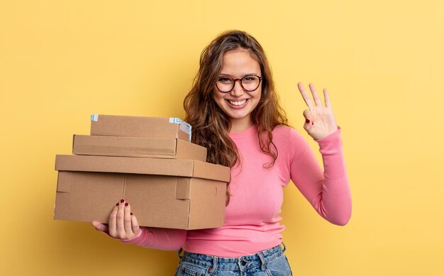 Hispanic pretty woman smiling and looking friendly, showing number three. storage concept