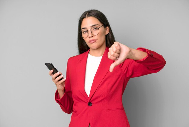 Hispanic pretty young adult and expressive businesswoman using a telephone