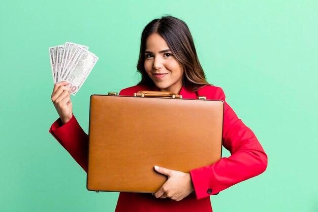 Hispanic pretty young adult woman with a suit case with banknotes