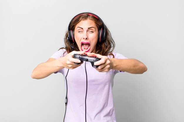 Hispanic pretty young woman playing with headphones and a control gamer concept