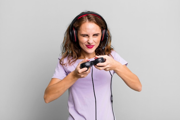 Hispanic pretty young woman playing with headphones and a control gamer concept