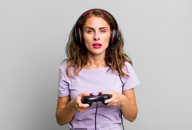 Hispanic pretty young woman playing with headphones and a control gamer concept