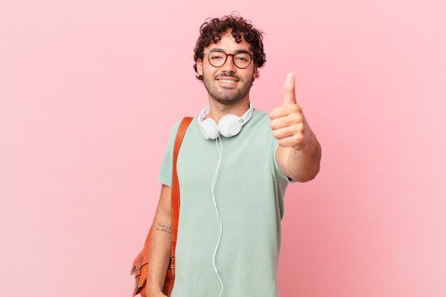 Hispanic student feeling proud, carefree, confident and happy, smiling positively with thumbs up