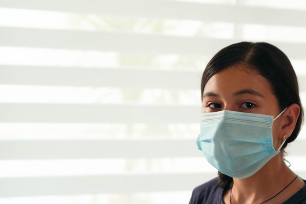 Латиноамериканский студент в маске в первый день возвращения в школу во время отключения от пандемии