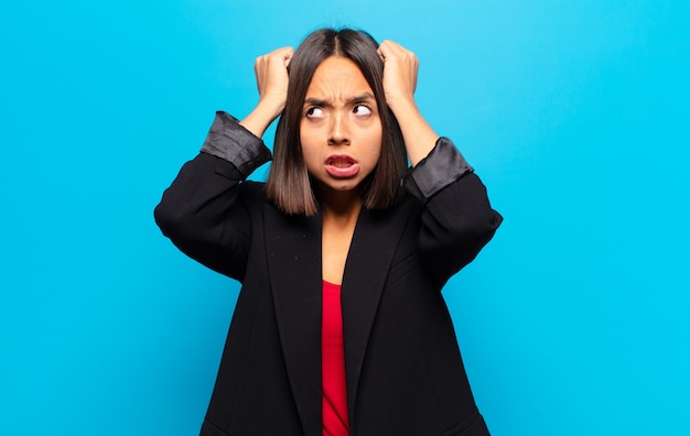 Hispanic woman feeling frustrated and annoyed, sick and tired of failure, fed-up with dull, boring tasks