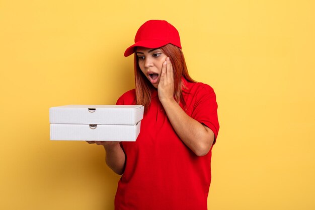 Hispanic woman feeling happy, excited and surprised. take away deliver concept