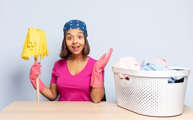 Hispanic woman feeling happy, surprised and cheerful, smiling with positive attitude, realizing a solution or idea