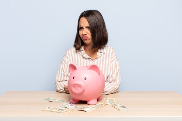 Hispanic woman feeling sad, upset or angry and looking to the side with a negative attitude, frowning in disagreement