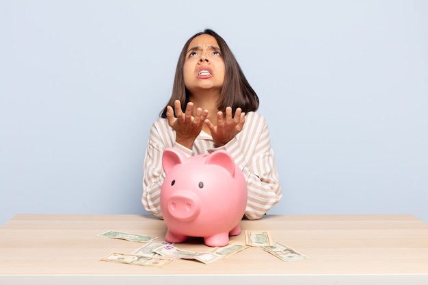 Hispanic woman looking desperate and frustrated, stressed, unhappy and annoyed, shouting and screaming