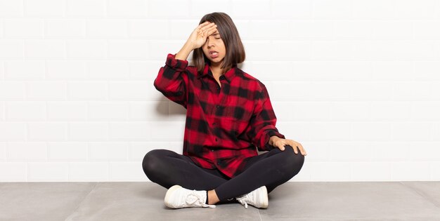 hispanic woman looking stressed, tired and frustrated, drying sweat off forehead, feeling hopeless and exhausted