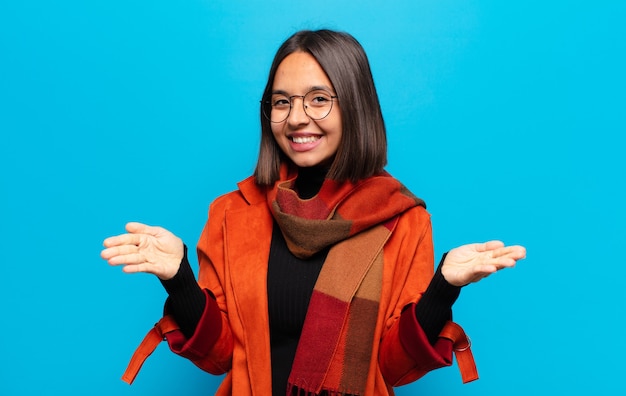 Hispanic woman smiling cheerfully giving a warm, friendly, hug, feeling happy and adorable