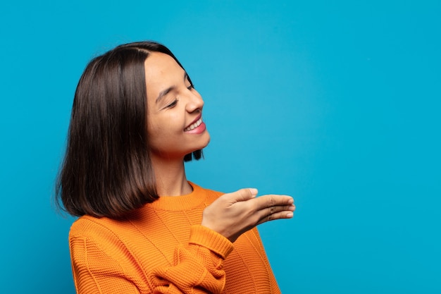 Hispanic woman smiling, greeting you and offering a hand shake to close a successful deal, cooperation concept