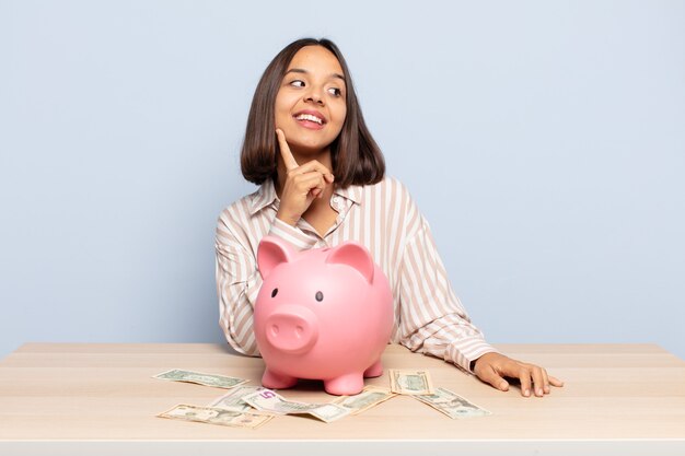 Hispanic woman smiling happily and daydreaming or doubting, looking to the side