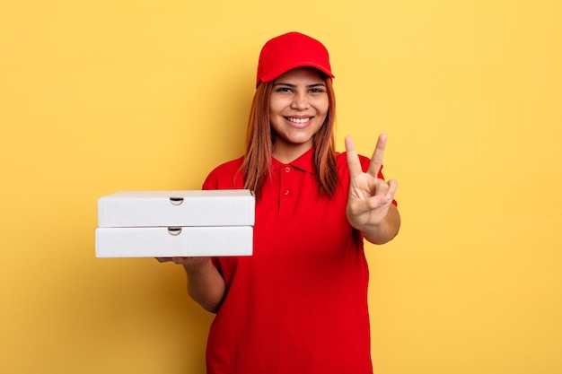 Hispanic woman smiling and looking happy, gesturing victory or peace. take away deliver concept