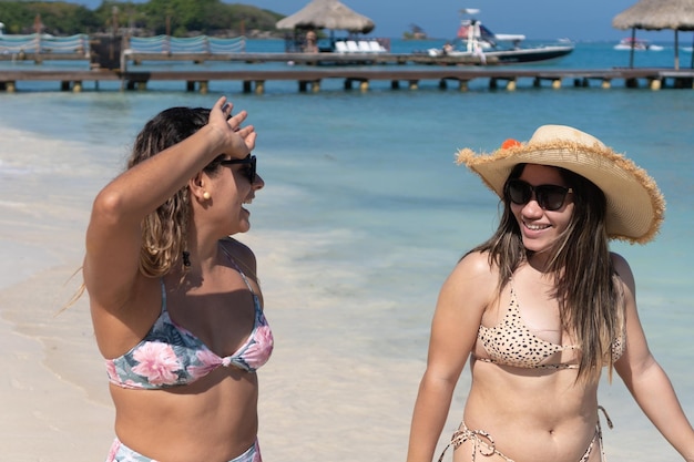 Hispanic Women enjoying summer vacations on beach