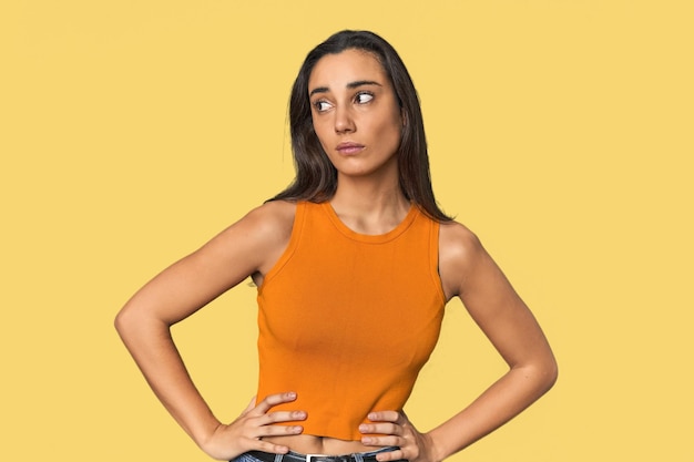 Photo hispanic young woman confused feels doubtful and unsure