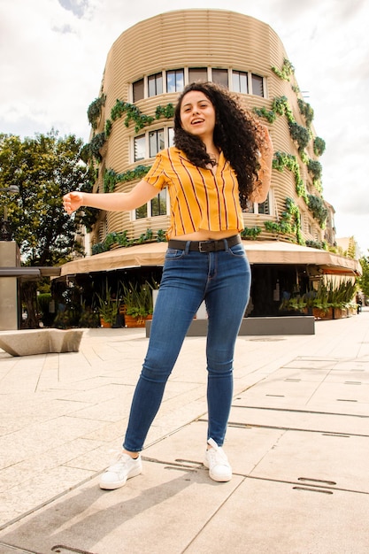 hispanic young woman posing in the street