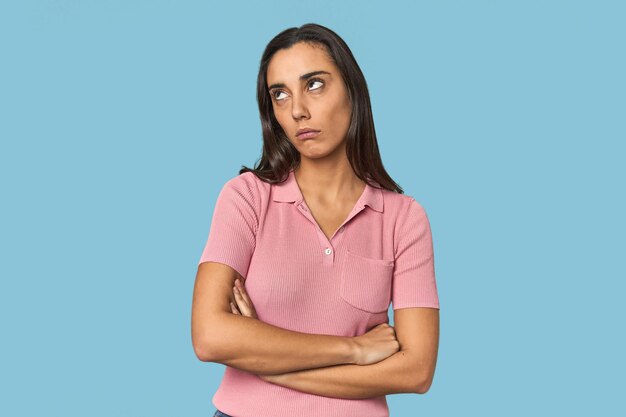 Hispanic young woman tired of a repetitive task