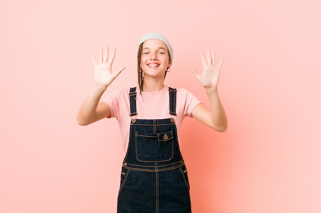 Hispter teenager woman showing number ten with hands.