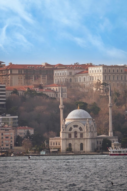 Historic architecture mosque and ferry on river in istanbul