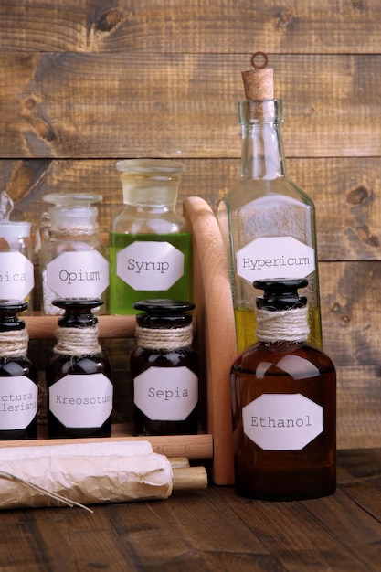 Historic old pharmacy bottles with label on wooden background