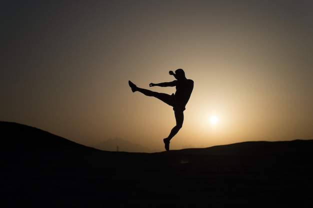 Hit your goal. Silhouette man motion jump in front of sunset sky background. Daily motivation. Healthy lifestyle personal achievements goals and success. Future success depends on your efforts now.