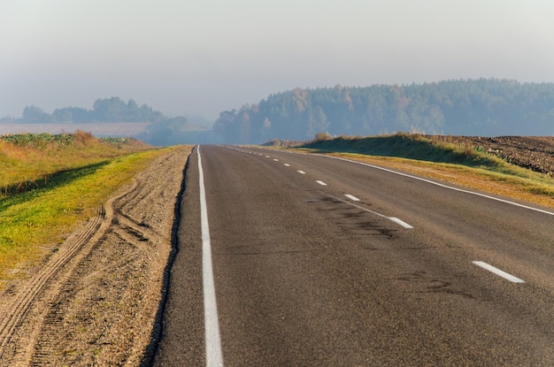 Hitchhiking empty road freedom of choice car on the highway on a sunny day