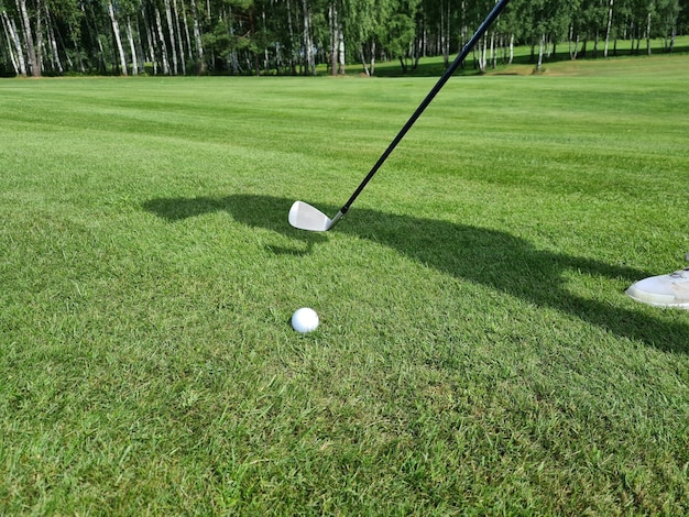 Hitting golf ball on field with golf club