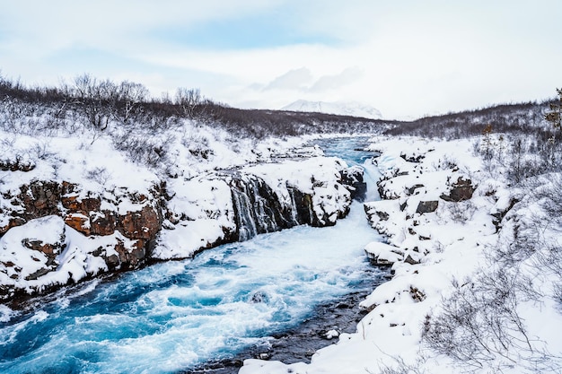 Hlauptungufoss waterfall the 'iceland's bluest waterfall' blue
water flows over stones winter iceland visit iceland hiking to
bruarfoss waterfall