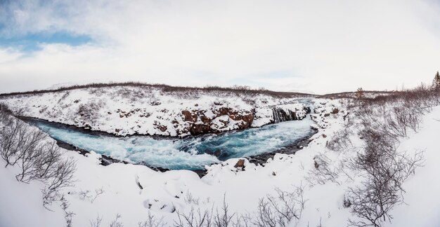 Hlauptungufoss Waterfall The 'Iceland's Bluest Waterfall' Blue water flows over stones Winter Iceland Visit Iceland Hiking to bruarfoss waterfall