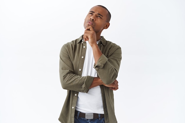 Hmmm interesting. portrait of thoughtful handsome, smart african american man thinking, making choice