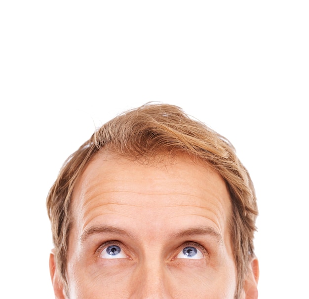 Hmmm very interesting Cropped shot of the upper half of a young mans face looking up at copyspace