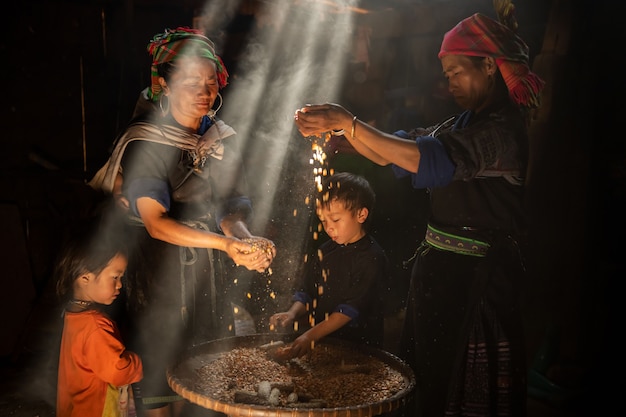 Hmong hill tribe family sorting corn seeds in their home, Vietnam Date 01/08/2021