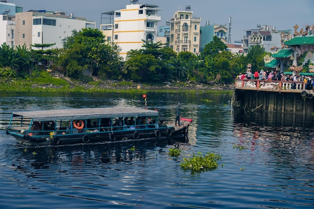 Ho chi minh city vietnam 13 feb 2022 visitors to phu chau\
temple phu chau mieu by boats is located in the middle of a branch\
of the saigon river floating on vam thuat river