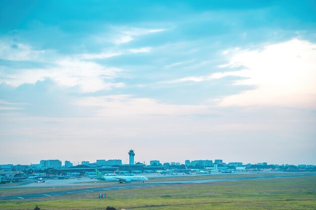 Ho chi minh city vietnam feb 12 2022 airplane fly over urban\
areas preparing landing into tan son nhat international airport and\
takes off in tsn airport