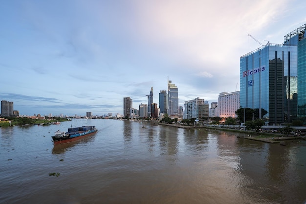 Ho Chi Minh Viet Nam 8 July 2023 Aerial view of Bitexco Financial Tower building Century Link train tracks buildings roads and Saigon river in Ho Chi Minh city