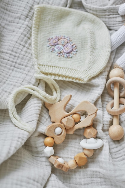 Hobbies and handicrafts. Knitted beanie with handmade embroidery. Wooden toys, rattles, teethers, nipple holder. Baby development, fine motor skills. Children and newborn products and accessories.