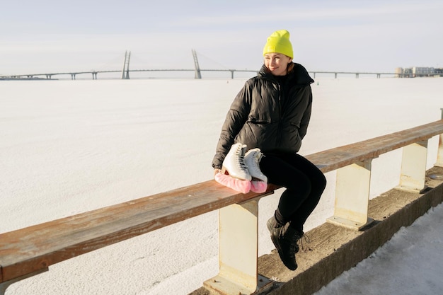 Hobby woman skating in winter in the park Sportswear and a yellow warm hat