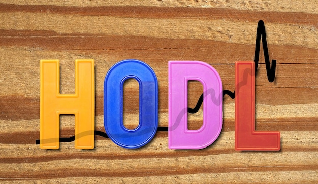 Photo hodl term derived from misspelling of hold that refers to buy and hold crypto currency