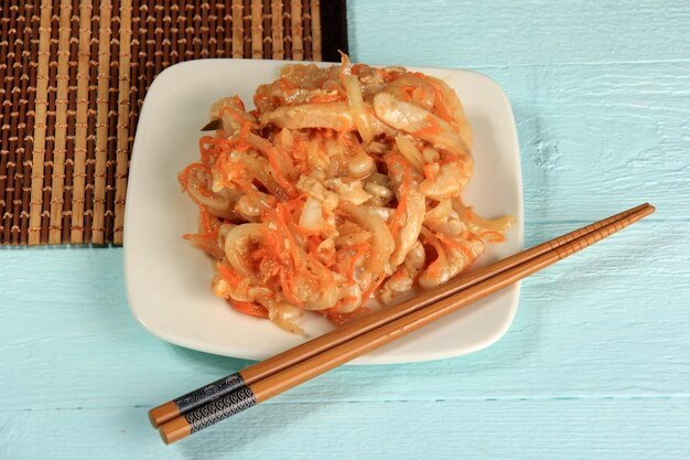 Hoe - Sliced Raw Fish with onions and carrots on a bamboo background