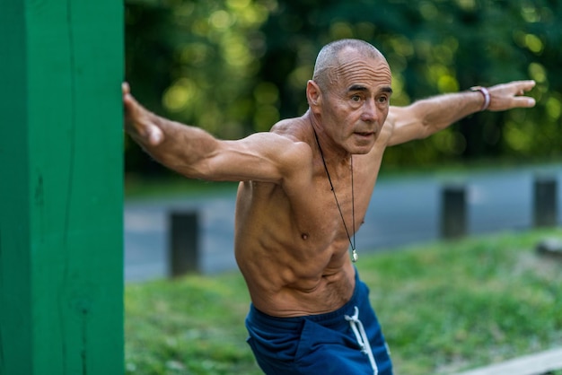 Hogere man die buiten traint in een openbaar park