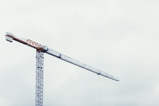 Hoisting crane on sky