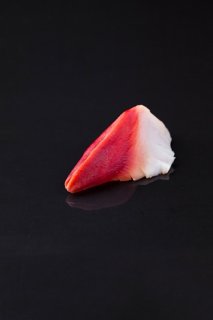 Hokkigai sushi on a dark background