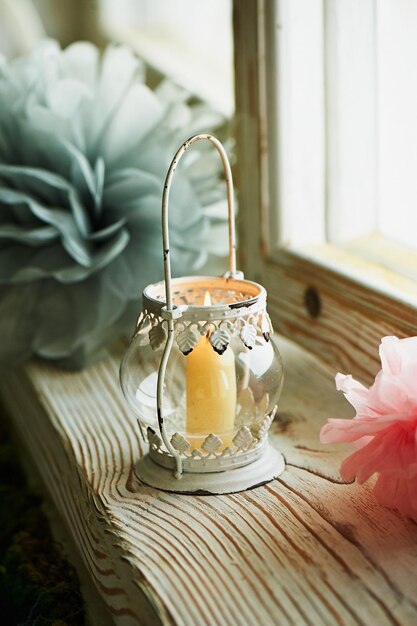 Holder white candle with Oriental ornaments swirls a burning