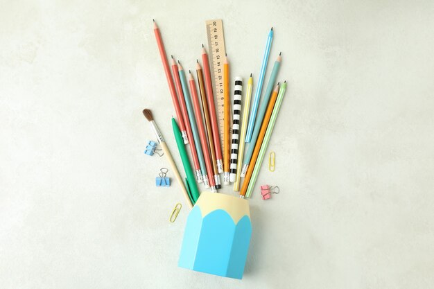 Holder with stationery on white textured table