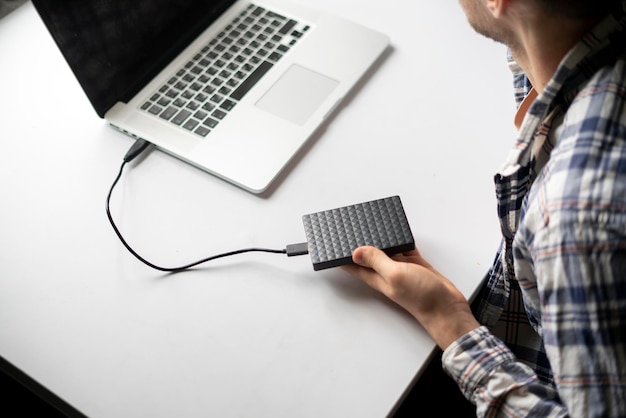 A holding backup external hdd with archive and connect it to the laptop