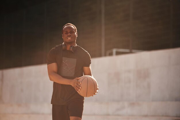 Photo holding ball in hands young black man