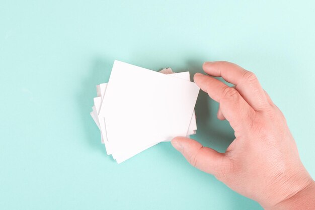 Holding a blank business card in the hand, copy space for text, marketing and advertising concept