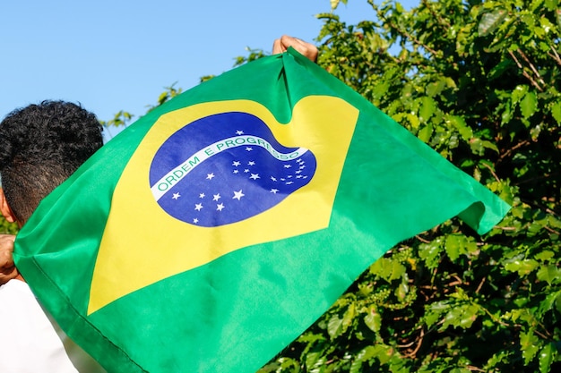 Holding the brazilian flag in the wind