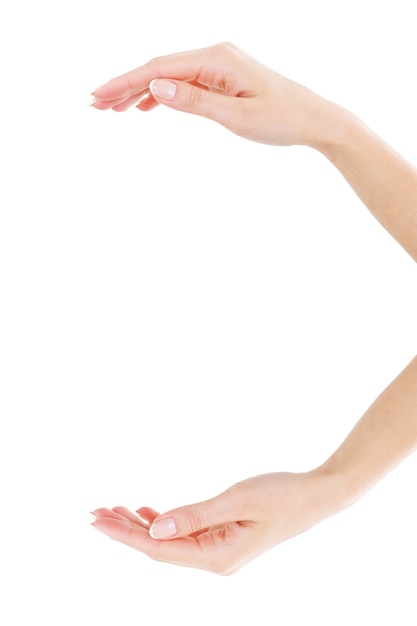 Holding copy space. Close-up of beautiful female hands holding copy space while isolated on white